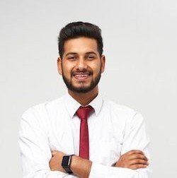 portrait of young indian top manager in t shirt and tie crossed arms and smiling on white isolated wall free photo